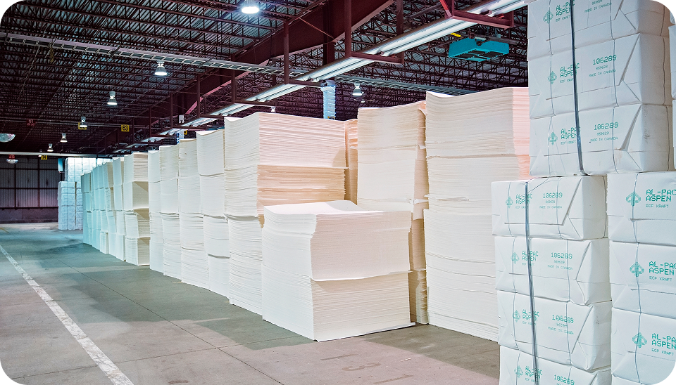 Stacks of high-quality pulp sheets stored in a warehouse, ready for global distribution.