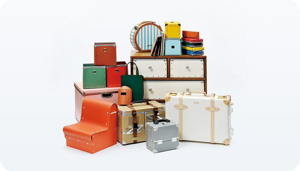 Processed product samples, including a suitcase and chair, made from specialty paper and functional materials.